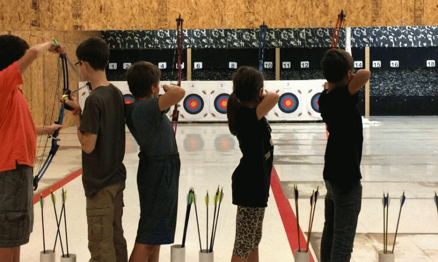 The archery team shoots at target down the lane at practice.