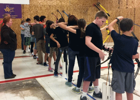 The archery team prepares to shoot arrows during practice.