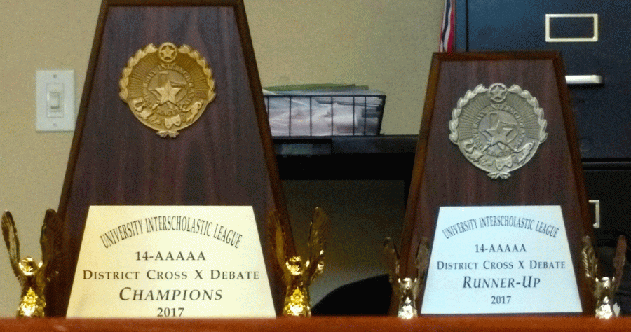 The two CX Debate District competition trophies, one for District Champion, left, and the other for District Runner-Up, right.