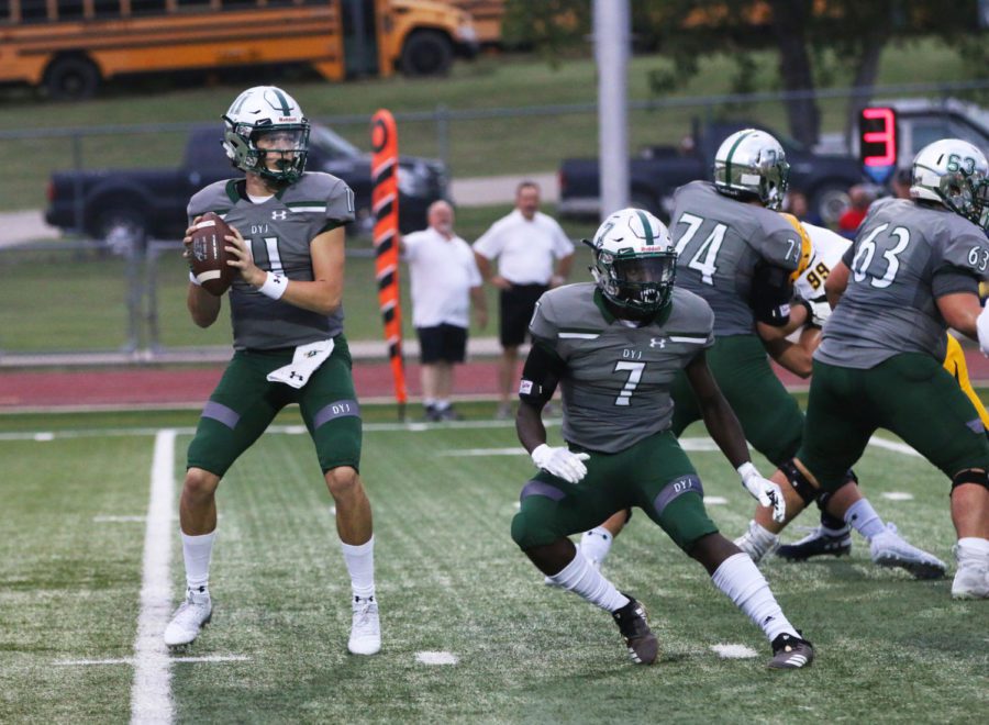 Senior quarterback Keegan Shoemaker, No. 11, drops back to pass in a game against the McKinney Lions on Sept. 20. Shoemaker finished Thursday with 156 yards and three passing touchdowns. His performance helped the Eagles to a 35-7 homecoming game win against the Lions.