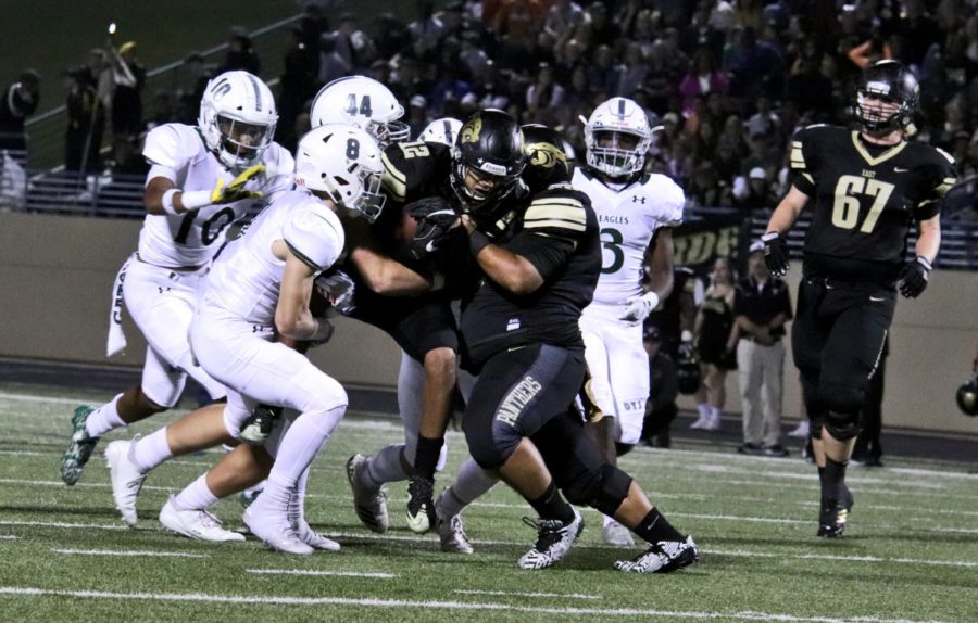 Prospers defense looks to bring down Plano East wide receiver Braylon Henderson, No. 12. Henderson tallied 153 yards and one touchdown. His performance helped Plano Easy past Prosper 26-14.