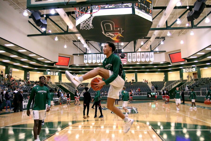 Senior Josh Davis, No. 11, warms-up before a game last season. Davis recently hit the 1,000-point mark in a game against Marcus High School Dec. 4. Scoring a thousand points, along with a win, was a big deal that night, Davis said. 