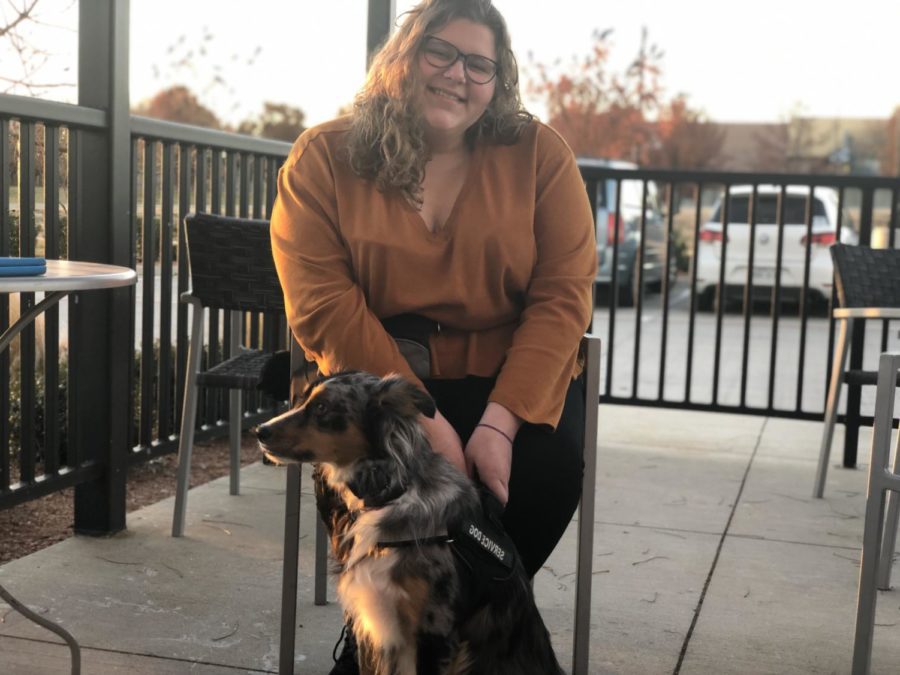Student Jennifer Sieira sits with her service dog, Hero.  After a battle to bring him to campus, she is able to have him ready to assist her at all times.  You wouldnt coax a wheelchair. You wouldnt coax an oxygen tank, so dont do it to a service dog, Sieira said. Its medical equipment. Its for me, not for you.