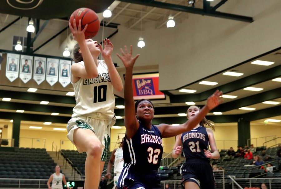 Freshman Hadley Murrell hops over McKinney for a layup in the second half. McKinney Boyd small forward Olivia Doles attempts to stop the layup. Murrell scored 5 points that night. 