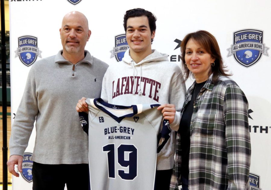 Keegan Shoemaker stands alongside his parents as he receives his All-American jersey. Shoemaker committed to Lafayette college earlier this year. Shoemaker led the football team to nine wins in his senior season at quarterback.