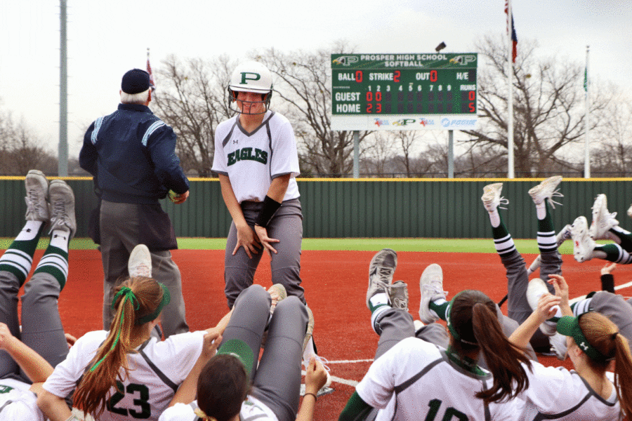 Riley McDaniel, No. 11, and teammates celebrate after a home run in the second inning. This knock gave the Eagles an early 5-0 lead against Pilot Point in the Prosper tournament. Although the preseason tournaments are vital for team chemistry and overall record, the district games are crucial for the Lady Eagles playoff chances. Sports Writer and Editor Zach Markey said.