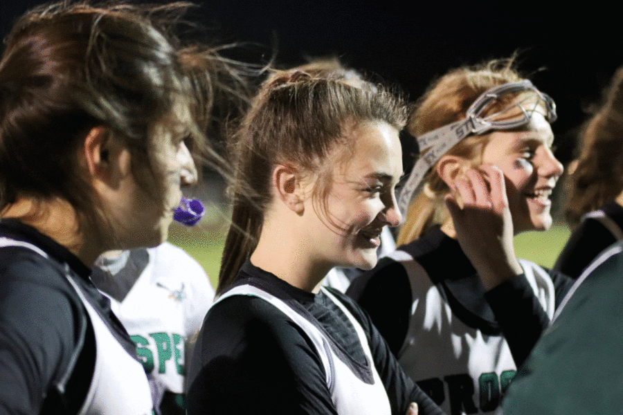 Prosper Lady Eagles Lacrosse members sophomore Angie Ruiz, freshman Amandalyn Garst, and freshman Mallory Griffiths gather with teammates at Frontier Park on Feb. 25, the same evening as their win against Ursuline 9-3. Ruiz made six of those goals. 