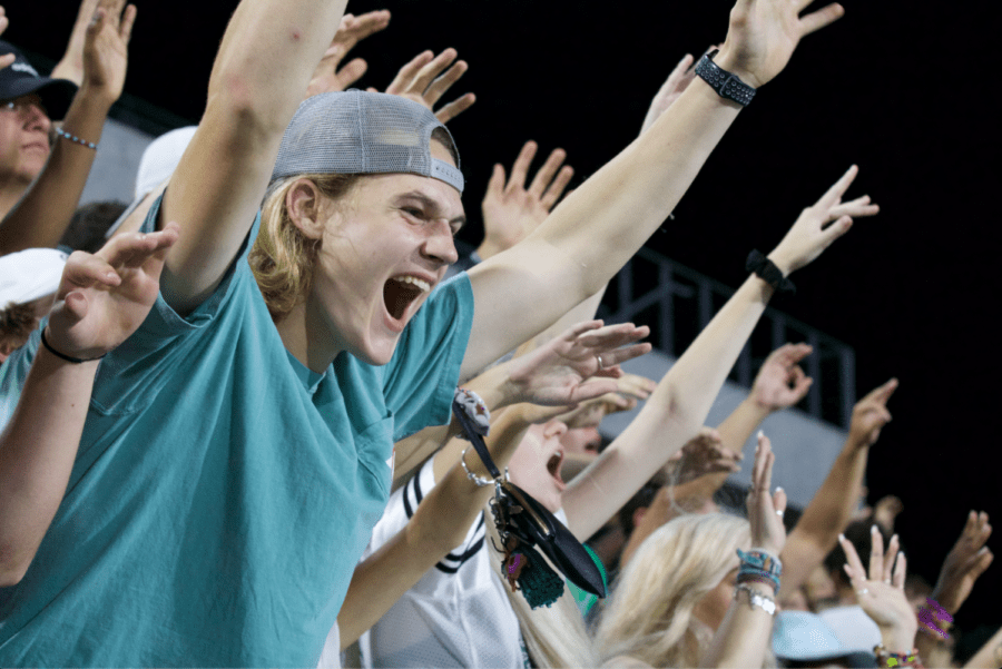With hands lifted high, senior Hunter Sheffield does not hold back his cheers at the Eagles matchup against McKinney High Friday, Sept. 20. Although there was a light rain shower late in the third quarter, the student section broke out to sing Sweet Caroline together. Prosper came out on top  with a win over the Lions 49-14. My favorite moments of Friday Night Lights are the memories, Sheffield said. I always tend to meet new people at the game and always establish a friendship, or get to know them better when its under the lights.