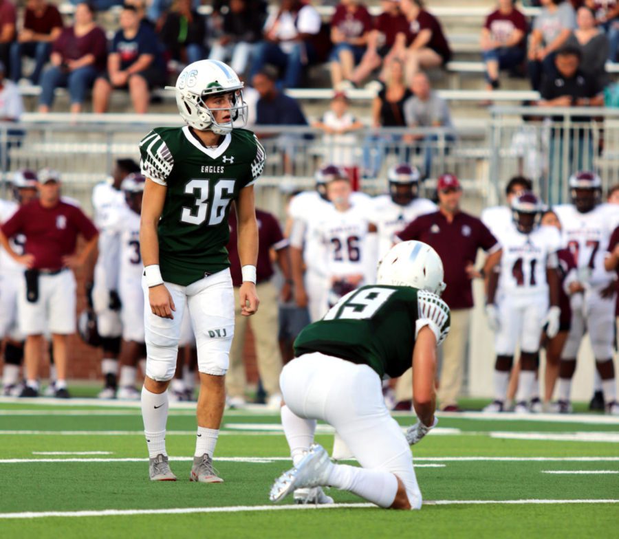 Junior Brad Larson prepares to kick a PAT during the game against Keller Timber Creek, Sept. 6. He has 11 points so far this season. This is his first year on varsity. Dont give up, Larson said. Theres always hope.