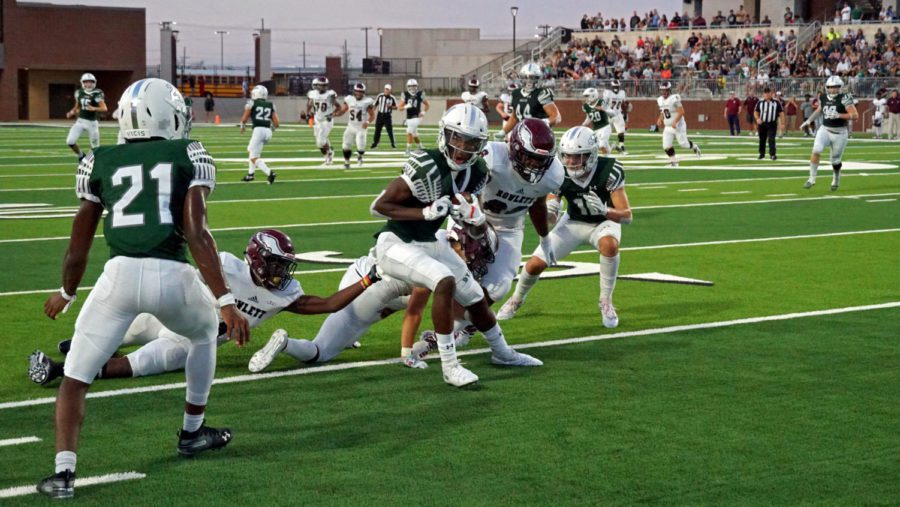 Sophomore Tyler Bailey, No. 4, breaks a tackle on his way to the end-zone. After conceding first, the Eagles came-back to win 31-7. Rowlett failed to put up points during the Eagles 31-point run. 