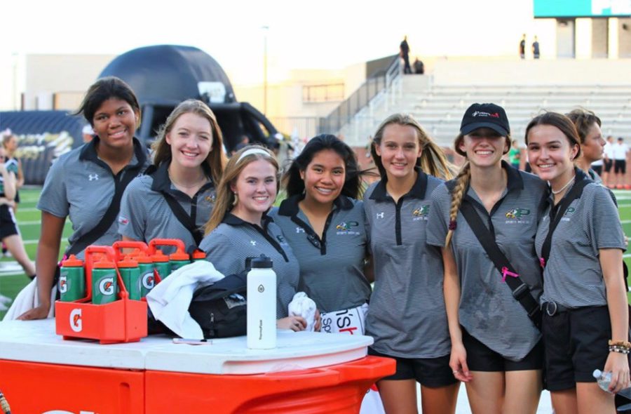 The student athletic trainers - senior Tasha Sayles, senior Ashlyn Wilkes, senior Kelly Cutler, senior Grammy Kornkanok Sophonsakulrat, junior Paige Benzick, junior Christian Folmar and sophomore Kylie York - stand and talk before the Sept. 27 varsity game against Plano East. In the attached column, sophomore athletic trainer and writer Kylie York covers the benefits of this program. Even if learning about sports medicine or anything medical-related isn’t an interest or hobby of yours, I still recommend giving it a try. York said. Student athletic trainers are students who attend games, make sure all players have water, wrap ankles and wrists to prevent injury, and look out for the players overall health and safety.