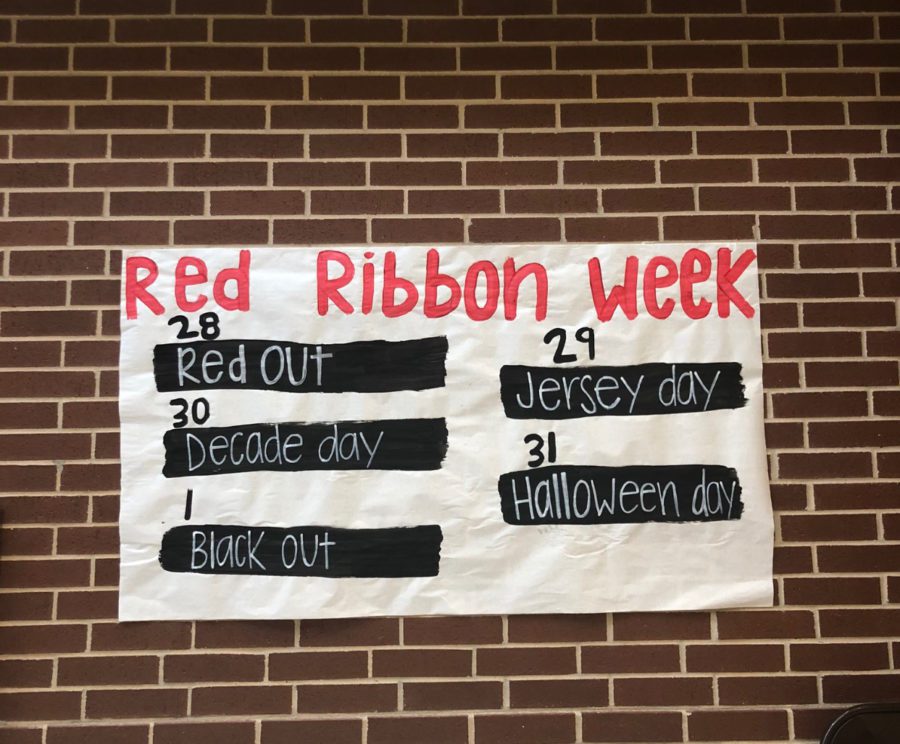 A banner displays the dress up days for Red Ribbon Week.Monday is Red Out, and we will be giving out little red ribbons to everyone during lunch, student council sponsor Amy Viars said. Tuesday is Jersey Day, and we are trying to promote a healthy lifestyle, so we will actually have an inflatable obstacle course during lunch for the students. Wednesday is Decades day, and we will be selling red glow sticks to use during the pep rally. Thursday is Halloween costumes. Friday is Black Out for the pep rally. The Black Out pep rally will take place on Friday, Nov. 1. 