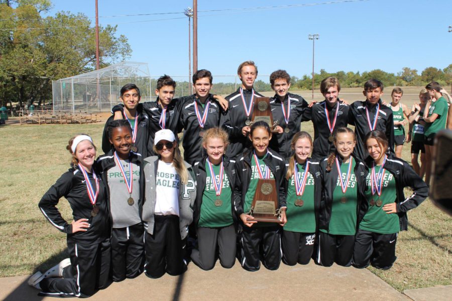 The winning runners take a moment with their district trophies on Oct. 18. “It felt amazing (to win district), just like last year we won districts and swept the whole thing. This year we are really excited to make it out of regionals and then go to state, junior Alexis Svoboda said. I think regionals is gonna go great. Both girls and boys varsity placed first at the district meet. Both junior varsity teams placed second overall.