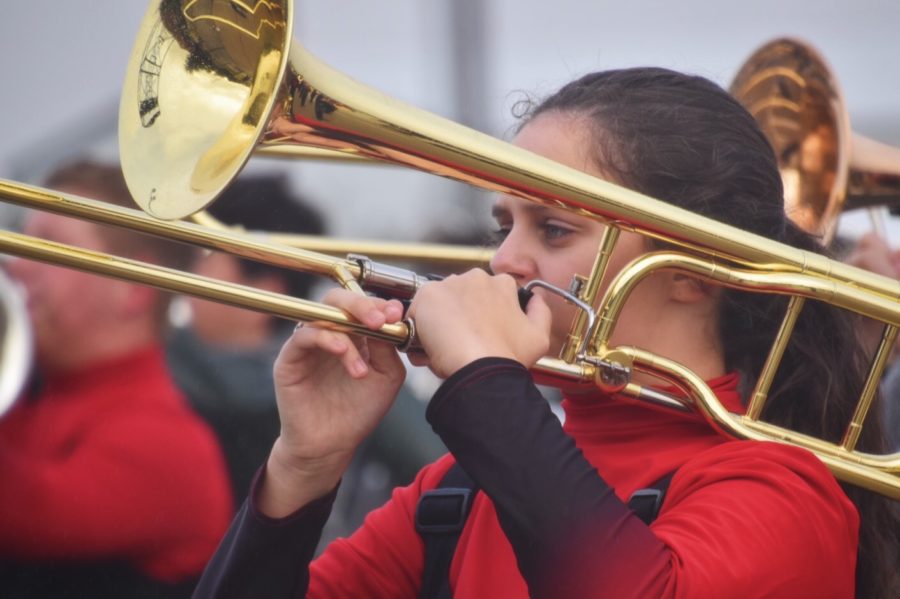 Junior Minette Du Plooy playes her trombone in a run-through of the show before the band competed at Duncanville. I love marching shows, just because of how fast paced they are, Du Plooy said. This is Du Plooys second year in The Mighty Eagle Band. 