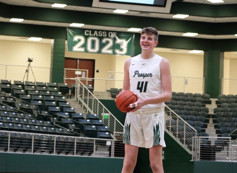 Smiling at his teammates, Conner Kern, No. 41, takes some shots before second half. Kern got multiple rebounds and put up a few points to bring the Eagles to victory against the Rams. The varsity Eagles play on Dec. 5-7 in the PISD Classic.   