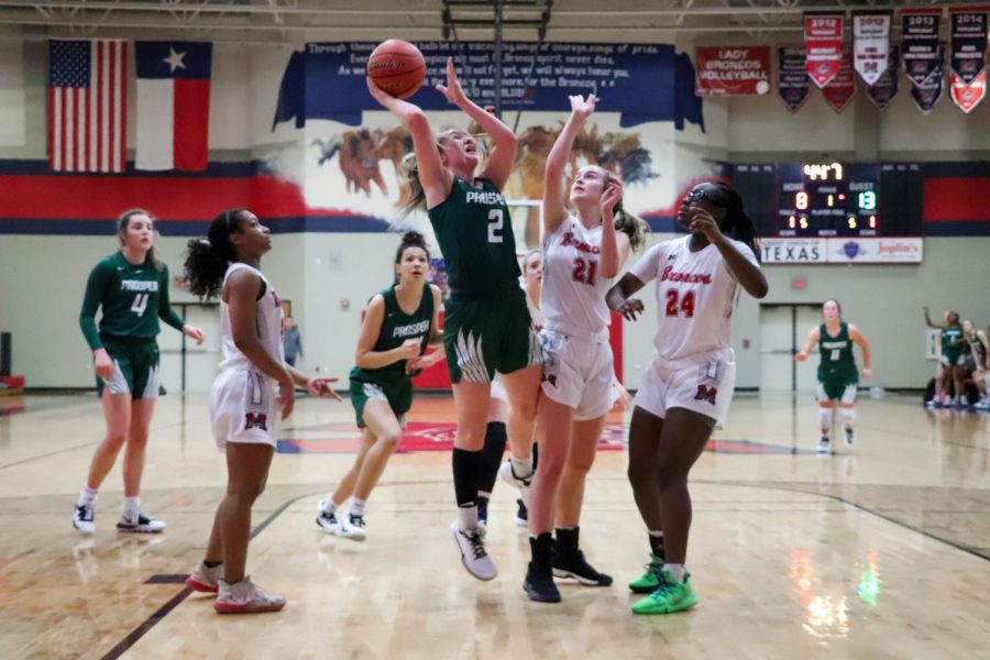 Despite being blocked and having the attention of three guards, sophomore Peyton Mosley goes in for a lay up. Mosley missed the shot, but she made up for it when she made both free throws. Her shots helped the Eagles win 48-35 against the Broncos.