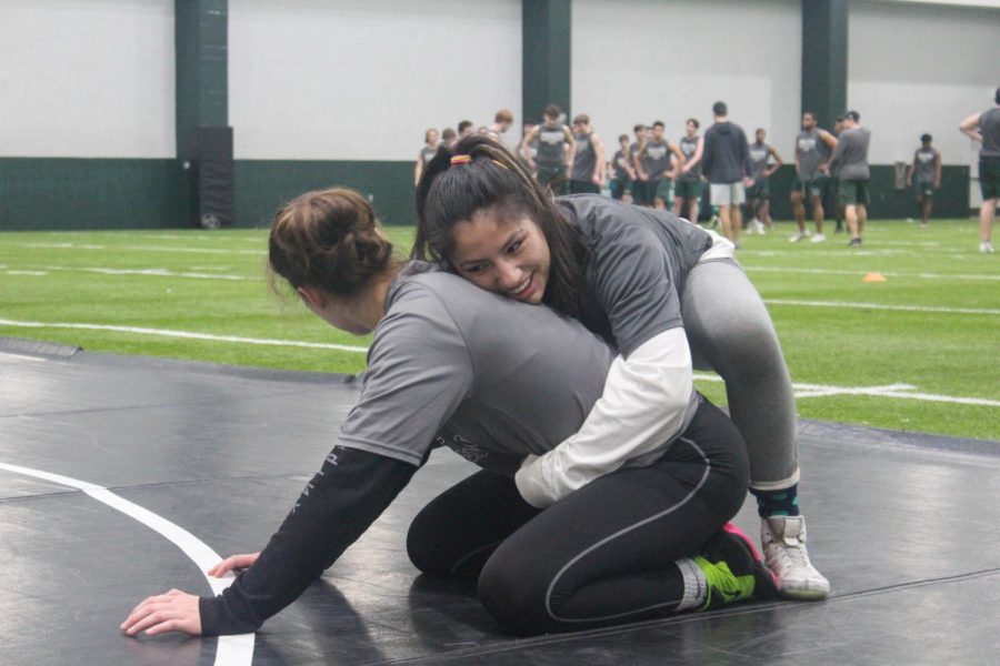 Sophomore Taylor Martinez works to improve her wrestling moves in preparation for the state tournament. She placed first at the regional  competition at Allen high school last week. Martinez will go on to compete at the state championship tournament in the 138 weight class.