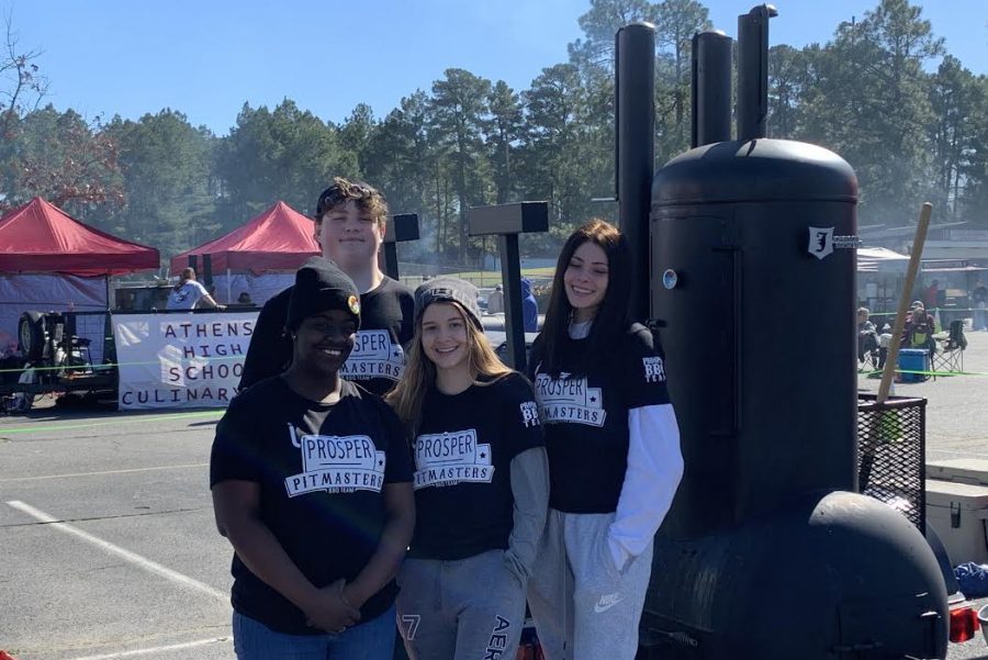 The Prosper Pitmasters barbecue team members Maddox Rains, Ashmani Clifford, Sydney Fisher and Kaley Folkins pose at the White Oak Regional barbecue competition. This is the teams first year together and competing. For their first competition, they placed 13th overall out of 32 high schools.