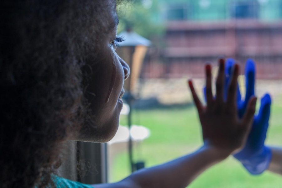 Nine-year old London-Olevia Brown cries as she presses her hand to the gloved hand of her adult sister, Itzy Hernandez, against a window. Social distancing is a necessary measure that many countries have undertaken to slow the spread of the coronavirus. But what will its long term effects be, aside from flattening the curve? Columnist Kate L. Keeler examines the possible outcomes of humans being left without humans.  
