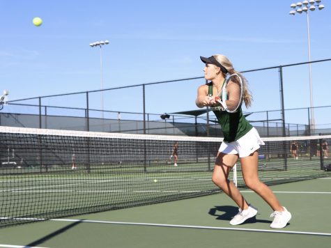 After rushing the net, senior Lauren Hallauer hits a backhand volley. Hallauer played doubles with junior Rebecca Gutierrez. The doubles team beat Denton Braswell   6-2, 6-2. 