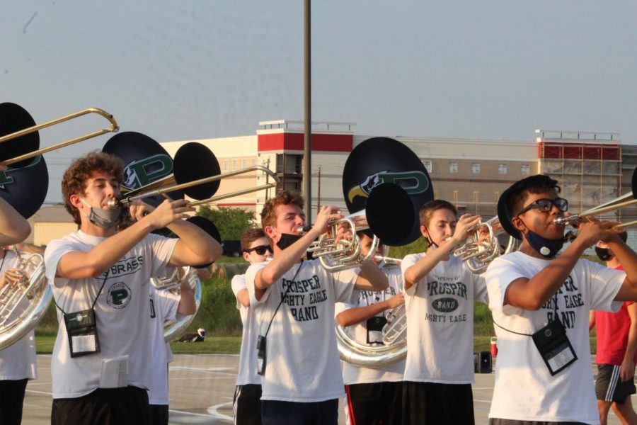 With their horns up, the Prosper Mighty Eagle Band practices their 2020 halftime show. The band is set to perform their show with scores from Earth Wind and Fire at home football games. 