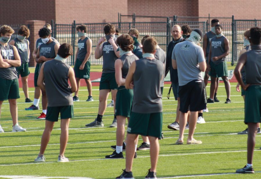 Socially distanced, Prosper Eagles football head coach Brandon Schmidt lectures players on junior varsity and varsity. Both teams were doing walk-throughs for their games on Thursday and Friday. “COVID has had a big impact on how we practice,” Schmidt said. “It has impacted almost every aspect of our program including position meetings, weight room workouts, and study hall.”