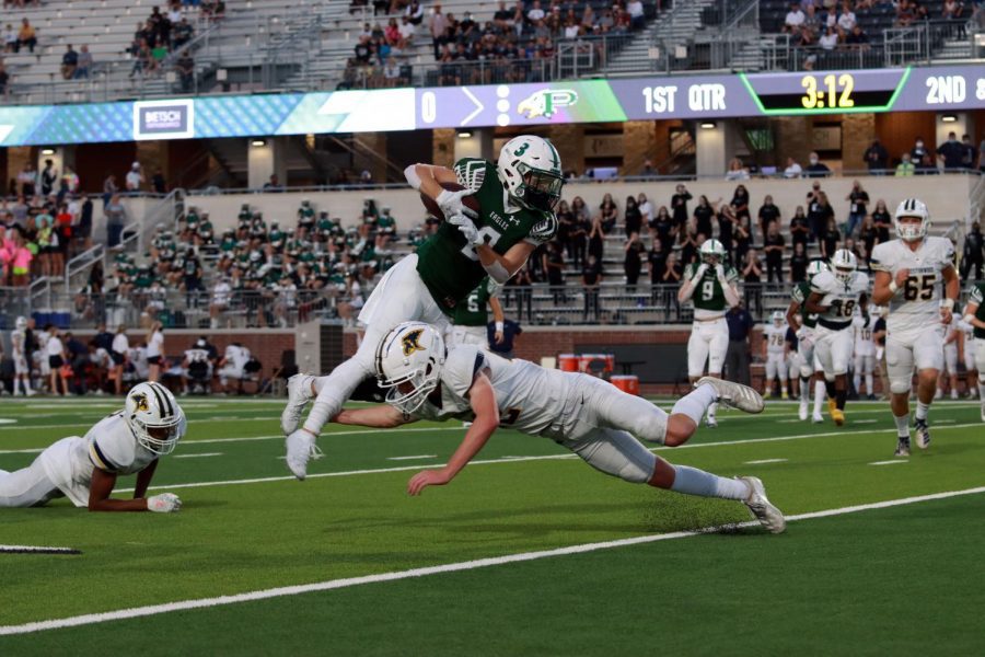 Diving+over+his+opponent%2C+senior+Keaton+Nickerson+makes+his+way+down+the+field.+Prosper+won+their+first+game+on+Sept.+25+against+Prestonwood+by+10+points%2C+27-17.+We+really+struggled+to+get+in+a+consistent+rhythm%2C+especially+offensively%2C+and+defensively+we+gave+up+too+many+big+plays%2C+head+coach+Brandon+Schmidt+said.+But+at+the+end+of+the+day%2C+were+one+and+zero.