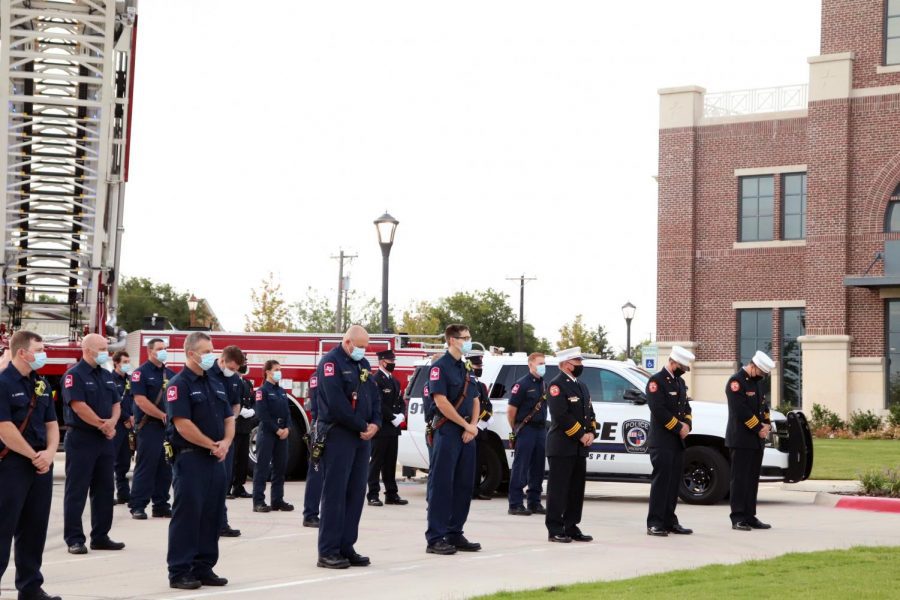The staff of the Prosper Fire Department stand heads bowed in remembrance of the lives lost in the terrorist attacks of Sept. 11, 2001. This fire station is located on East First Street. Community members in attendance were asked to comply with social distancing guidelines. 