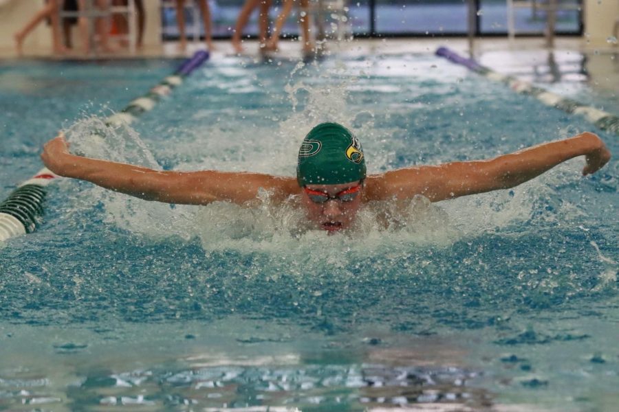 Coming up from his dive into his lane, Hayden Jestes breaks out with the first 50-yard butterfly leg.  Jestes, a senior, competes on the varsity team. He competed in the 200 individual medley event.