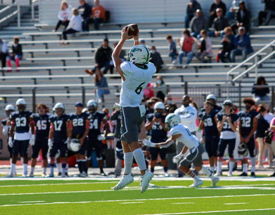 Catching a pass from his fellow teammate, outside linebacker Grant Peck, No. 6, jumps in the air. This was the Eagles first district game. They were a little rusty because of our quarantine situation, Coach Jakeob Garner said. But, they cleaned it up, and were looking forward to playing Guyer.  