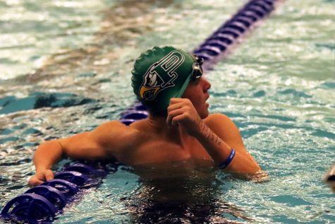 Following his 50-yard freestyle race, junior Lane White receives feedback from head coach Trey Sullivan. White placed first in the 50-yard boys freestyle event. He was yelling at me because I breathed every stroke, White said. I still won, but he said I couldve gone way faster.