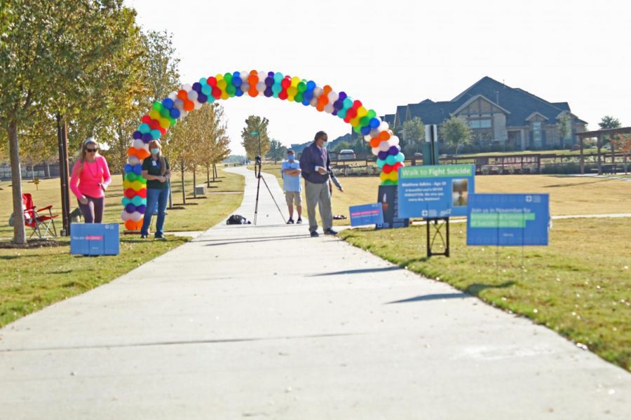 An arch of rainbow balloons marks the beginning of the walking route. Out of the Darkness Walk drew hundreds of participants to the Windsong Ranch neighborhood in Prosper Saturday, Nov. 7. I thought it was so cool to see how many people came out to support and raise awareness to suicide prevention, sophomore Hope Squad member Landon Bownds said. It was nice to see both schools and the shared community come together for a really important cause