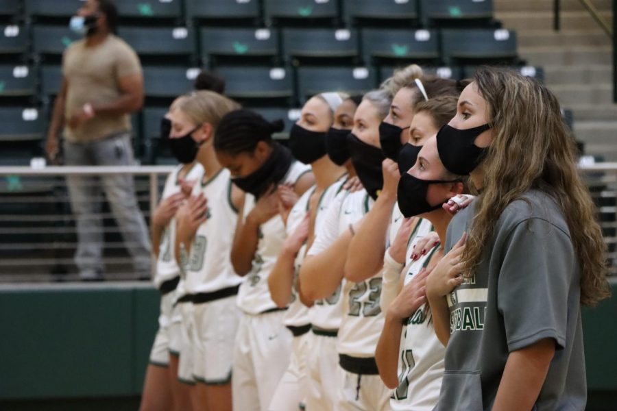 With their hands over their chests, the Lady Eagles stand while the national anthem is played. The team played the first game of the season on Saturday, Nov. 7, against Wylie. Previously, they played a scrimmage against Frisco Liberty Nov. 2.