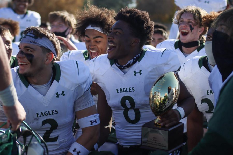 After the Eagles are  announced bi-district champions, No. 8 junior Tyler Bailey celebrates while holding the trophy.  Superintendent Holly Ferguson presented the team with the trophy. The Eagles won over the Flower Mound Marcus Marauders 38-19. 