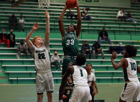 Arms raised for a dunk, senior Brandon Sofi reaches for the basket while Berkner defenders . The Eagles played the Richardson Berkner Rams on Tuesday, Dec. 1 at the Berkner Arena. The boys came off with a 61-44 win.