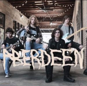 Sitting on a bench, members of Aberdeen position themselves with their instruments. Aberdeen members present themselves as a classic rock band with a mission. We are trying to start a revolution, junior Garrett Kurpens said. To bring rock n roll back to its former glory. 