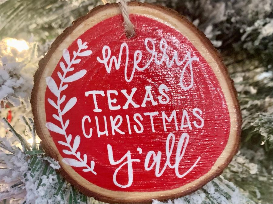 Dangling from senior Morgan Reeses family tree, an ornament reading Merry Texas Christmas, Yall reflects the tree lights. The family bought the ornament on their yearly trip to Santas Wonderland in College Station. This year, they opted to celebrate at home because of COVID-19.