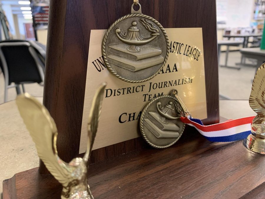 Displayed on a desk in the journalism news room, the UIL journalism district champion trophy sits with other UIL medals from this year. UIL academic teams competed on Friday, March 26 and Saturday, March 27. As of right now, Prosper will win the district championship.
