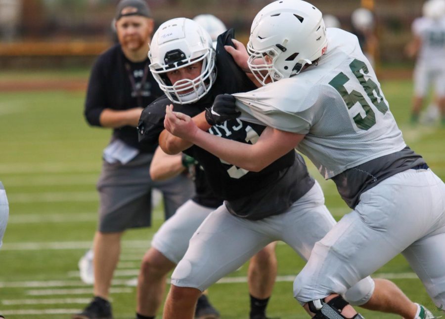 During a drill, sophomore Evan Bish blocks No. 56 sophomore Zach Barnhouse. Bish plays as a defensive end and Barnhouse plays as an offensive lineman. Spring ball is a time where we dont really have junior varsity or varsity, Bish said. We basically just work on getting stronger as players.