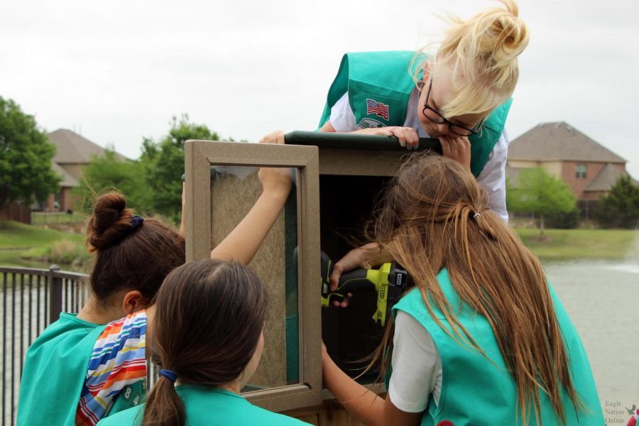 Working with her fellow Girl Scouts, Girl Scout Carsyn Overstreet holds the drill. After buying the supplies, the girls built the Little Free Library together and installed it on Tuesday, April 27. “The premise that the girl initially got started with was to reduce, reuse, recycle,” Girl Scout leader Kalli Overstreet said. “They came up with a ton of different options and one was to reuse books, since we all had books. We got in contact with the local neighborhood here, and the HOA and it just kinda spawned.” 
