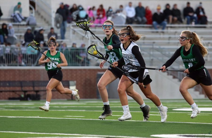 Storming across the turf, freshman Gretchen Teigen rushes past Southlake defenders. The game closed 18-6 with Prosper in the lead. It’s been super awesome getting to be apart of a team that has had so much success this season, Teigen said. I think we have all grown a lot as players, but especially as a team. We started the season as an underdog and are ending it as one of the top teams in the division, which has been a super cool experience. It’s been such a great season, and I’ve made so many great friends. 
