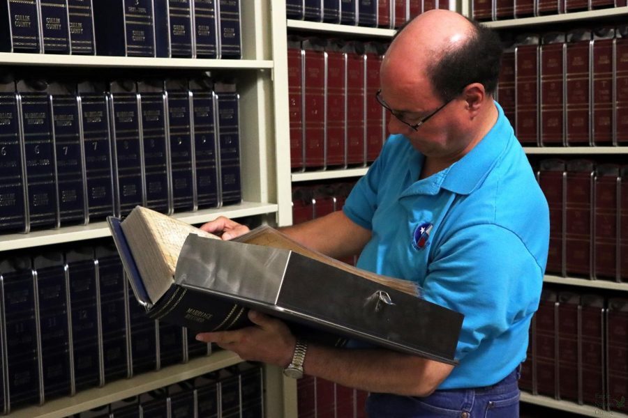 Paul Tinker Rosales reads a marriage record contained in a disaster-safe binder, stored in the shelves beneath the Collin County Courthouse. Rosales, part of a team of county employees led by county clerk Stacey Kemp, works with the office team to preserve records from 1800 to the present day. Collin Countys Courthouse is located in McKinney, Texas. 