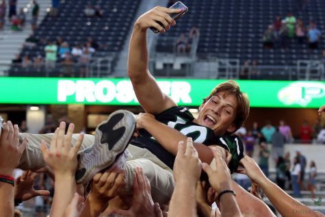 Phone raised to take a selfie, junior Harrison Rosar crowd surfs after Meet the Eagles. Rosar holds the position of quarterback for the varsity football team and also plays varsity baseball. Im very excited for this season, Rosar said. We have a whole bunch of weapons in the offense, a whole bunch of guys to replace on the defense, but Im sure our guys will step up and fill those roles.