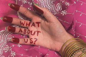 Gold bangles and vivid red paint decorate the hand of half-Indian, half-white junior Kalyani Rao. The words What about us? are written on her palm. The red paint is inspired by Raos memory of practicing a style of Indian classical dance, Bharatanatyam, as a child, where the hands and feet of the dancers would be painted red before a performance. Indian culture is so incredibly beautiful, Rao said. Im proud of my relatives from coming all the way to the United States from the vibrant country that is India.
