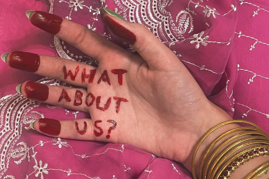 Gold+bangles+and+vivid+red+paint+decorate+the+hand+of+half-Indian%2C+half-white+junior+Kalyani+Rao.+The+words+What+about+us%3F+are+written+on+her+palm.+The+red+paint+is+inspired+by+Raos+memory+of+practicing+a+style+of+Indian+classical+dance%2C+Bharatanatyam%2C+as+a+child%2C+where+the+hands+and+feet+of+the+dancers+would+be+painted+red+before+a+performance.+Indian+culture+is+so+incredibly+beautiful%2C+Rao+said.+Im+proud+of+my+relatives+from+coming+all+the+way+to+the+United+States+from+the+vibrant+country+that+is+India.