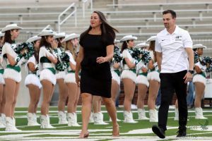 Walking across the field, swim coaches Lena Harrington and Keenan Fogelberg are introduced to the Prosper community for the first time. Harrington and Fogelberg were both hired this year. Harrington is the head swim coach and Fogelberg is the assistant swim and dive coach. 