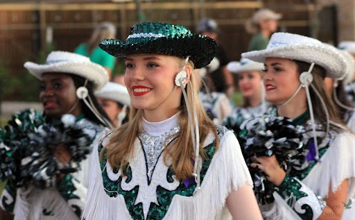 In the Homecoming parade, junior Kaley Carr walks down Coleman Street with the Talonettes drill team. Carr participates in her third year on the team and leads as Junior Lieutenant of the team. After the Homecoming parade occurred on Wednesday, Sept. 22, a community pep rally occurred in the PHS arena.