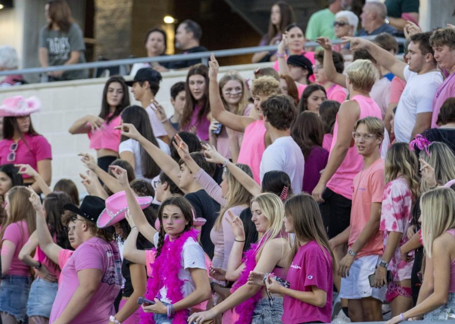 Before the game, the student section raises their hands toward the band for the fight song. The game was played Friday, Oct. 8, at 7 p.m. at Childrens Health Stadium. The theme was Pink Out.