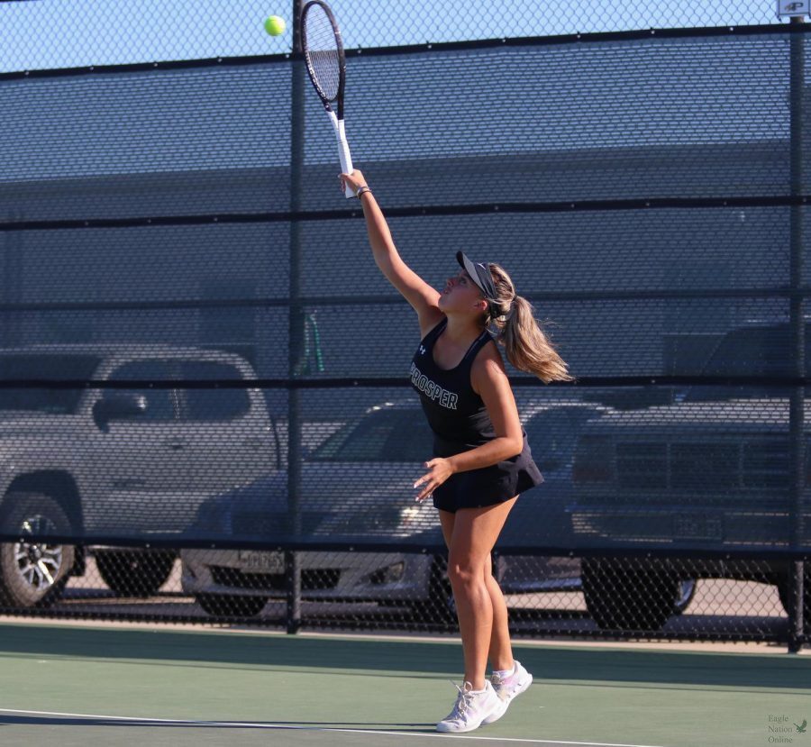Racket up high, senior Rebecca Gutierrez hits the ball toward her opponent in her singles match. Gutierrez played on the varsity team last year, as well. The Little Elm game marked their district quarterfinals. They played the  match at home Oct. 4 and started at 4 pm.