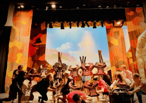 During rehearsal, The Lion King Jr. cast and crew work on stage as the set receiving final touches on stage. The show will be opening on Nov. 4. The students have been working on this production since late August. (Caption by Cate Emma Warren)